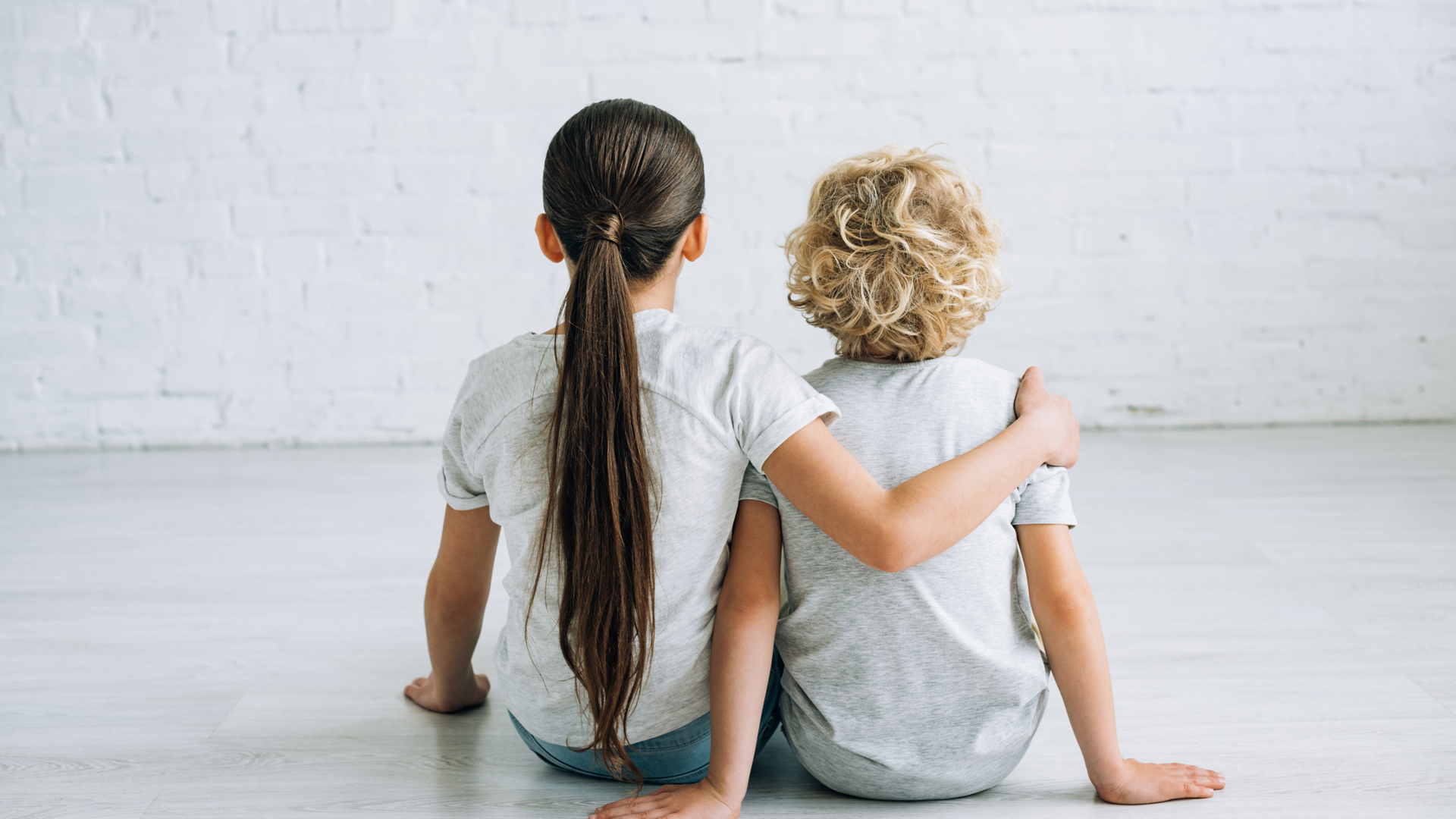 Back View Of Two Kids Embracing On Floor At Home 2024 11 19 08 04 30 Utc